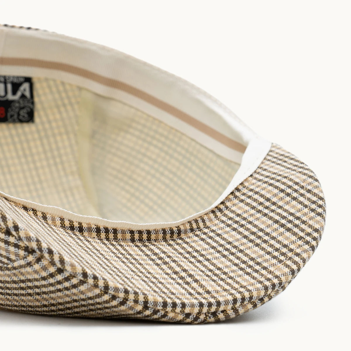 detalle interior gorra cuadros beige costuras y acabado